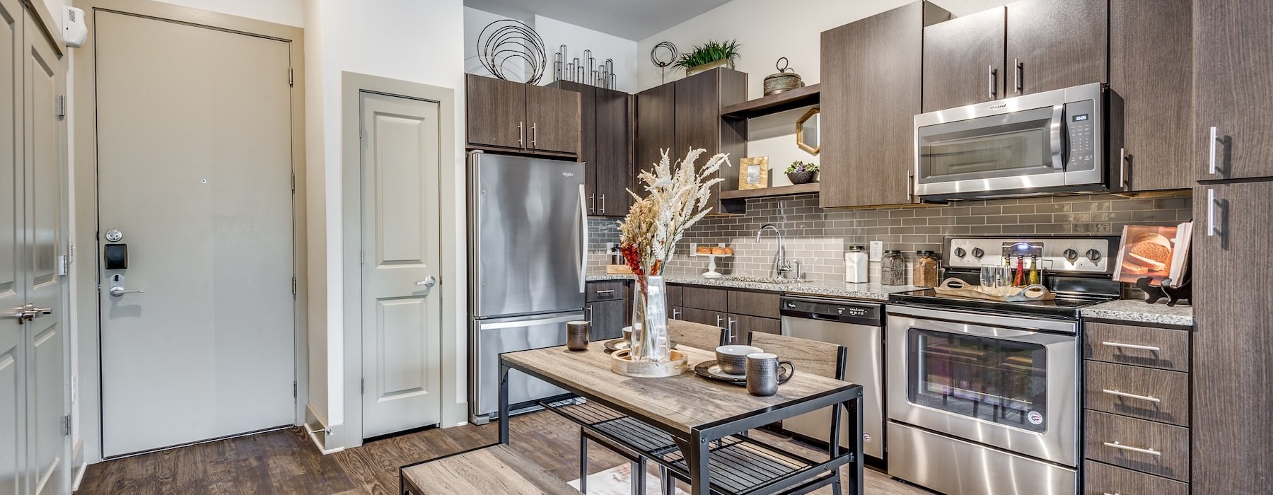 A kitchen with a table and chairs in Spring apartments.