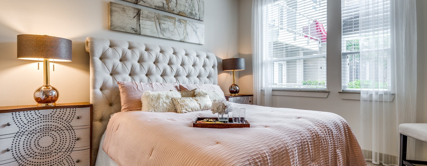 a bedroom with a bed and lamps