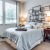 a bedroom with a bed and a shelf with lamps